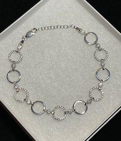 "Stunning women's or girl's iced out circle link bracelet Solid 925 sterling silver, rhodium finish to prevent tarnish Bracelets are adjustable from 7 to 8\" Iced out with high grade cz stones for an amazing shine! Weighs 8.2 grams 10mm wide Solid silver, will never turn your skin green. Contains no nickel or brass." Sterling Silver Chain Bracelet For Anniversary, Silver Round Chain Bracelet For Anniversary, White Gold Cubic Zirconia Charm Bracelet, Metal Charm Bracelet For Anniversary, Anniversary Metal Charm Bracelet, Sterling Silver Round Charm Bracelet, Silver Sterling Silver Tennis Bracelet, Silver Cubic Zirconia Round Bracelets, Silver Cubic Zirconia Round Bracelet