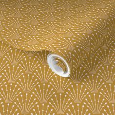 an orange and white wallpaper with fan pattern on it's side, in front of a yellow background