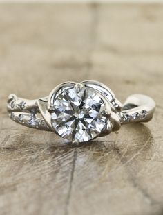 a diamond ring on top of a wooden table