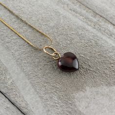 "This is a perfect little heart charm for your loved one. The natural red garnet gemstone heart is hand carved and measures 8x8mm and has a 6mm solid 14k yellow gold pendant bale. It is available with or without a 14k yellow gold, 16\" inch,  serpentine chain. Made of solid gold, not plated.  Dimensions: Garnet heart is 8mm in diameter and has a 6mm pendant bale. The 14k gold serpentine chain is .5mm wide and 16mm long. It has a 4mm Spring ring clasp and jump ring." Elegant Amber Jewelry For Valentine's Day, Brown Heart Charm Jewelry Gift, Valentine's Day Brown Heart Charm Jewelry, Red 14k Gold Heart Pendant Necklace, Red Heart Pendant Jewelry With Heart Detail, Heart-shaped Garnet Jewelry As Gift, Heart-shaped Garnet Jewelry For Gift, Red Heart-shaped Charm Jewelry, Heart-shaped Garnet Jewelry For Valentine's Day