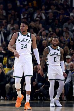 two basketball players standing next to each other on a court