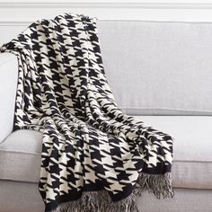 a black and white blanket sitting on top of a couch