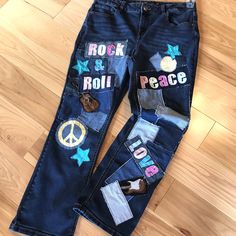 Upcycled patchwork jeans, Maurice's size 14 short, reworked denim hippie jeans.  These fun patch jeans have denim fabric patches along with the words "Peace, Love, Rock & Roll" and other various geometric patches.  This cute pair of  1970s-1980s vintage retro patched jeans would make a great outfit for a concert or festival, would be a great gift for a 70s-80s music lover...or keep for yourself if you have that  "hippie soul"! (WANT TO SEE MORE FROM THIS COLLECTION? Type RRPJ in this store's search field.) DETAILS: Size:  Women's size 14 short Brand:  Maurice's mid-rise Materials:  87% cotton, 12% polyester, 1% spandex MEASUREMENTS: Waist:  32 inches Hips:  40 inches Inseam:  28 inches Front Rise:  11 inches Back Rise:  16 inches Circumference bottom of leg:  17 inches Be sure to check the Fall Denim Bottoms With Patches, Hippie Patchwork Jeans For Spring, Hippie Reworked Denim Bottoms, Hippie Style Upcycled Denim Bottoms, Hippie Upcycled Denim Bottoms, Straight Leg Bottoms With Patches For Fall, Retro Patchwork Denim Pants, Retro Denim Patchwork Pants, Fall Straight Leg Bottoms With Patches