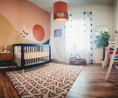 a baby's room with a crib and rug