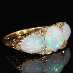 "I'm always on the lookout for marvelous opal rings, and I often come across 3 and 5 stone varieties in the very typical English Victorian fashion, but I have to admit that when I saw this particular ring my jaw just about hit the floor. Once I had lifted said jaw and tucked it back neatly into place, I had no choice but to slip this large and luscious beauty onto my finger and bring it home with me. This is, without a doubt, the biggest, boldest and most fabulous example of a 3 stone ring I hav Antique Opal Ring, Opal And Diamond Ring, Edwardian Jewelry, Opal Ring Gold, Ancient Jewelry, European Cut Diamonds, Opal Ring, Multi Stone Ring, Glasses Accessories