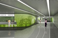 people are walking through an airport lobby with green walls and ceiling lights on the ceiling