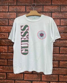 Vintage 80s Guess New York Surfing Style Spell Out Logo T Shirt / Hip Hop 90s / 90s Streetwear T Shirt Made In Usa Size M Condition : Good Used Size on tag : MColour : GreenishBrand : guessMeasurement : Armpit to armpit -21”Length - 24”Material : Old CottonMade In: USA THE SHIPPING (Your Choice Please read)1. The shipping cost is USD 20 via Malaysian Registered Postage With Tracking Number.It will take 2-4 weeks or more for delivery, depends on your custom checking.2. Add USD 10 for speedy deliv 90s Style Crew Neck T-shirt With Logo, 90s Style White Tops With Vintage Print, Surfing Style, Hip Hop 90s, Streetwear T Shirt, Guess Men, Clothing Designs, 90s Streetwear, Logo T