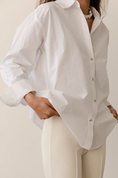 A season-less essential crafted with 100% cotton poplin, featuring a subtle dropped shoulder and tortoise-like buttons. Made in Los Angeles Timeless Cotton Shirt For Daywear, Classic Everyday Tops With Button Closure, Oversized Cotton Tops With Snap Buttons, Timeless Shirt With Button Cuffs And Relaxed Fit, Timeless Relaxed Fit Tops With Button Closure, Effortless Everyday Shirt With Buttons, Effortless Button Shirt For Everyday, Oversized Tops With Snap Buttons For Everyday, Classic Shirt With Buttoned Pockets For Everyday