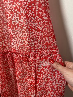 This floral maxi dress is the stuff of dreams! It is Union Made and from the 1970's, made predominantly of cotton and polyester. It's a gorgeous dress and perfect for spring and summer! It is a coral pink color with a white floral pattern on it. It is closest to a modern day size 2/4, but here are the exact measurements taken lying flat and doubled: Shoulders: 15 inches Chest: 28 inches Waist: 24 inches Hips: 30 inches Shoulders to Hem: 50 inches This dress has an inner lining too, so it keeps i Red Retro Maxi Dress For Summer, Red Retro Maxi Dress For Spring, Retro Red Maxi Dress For Spring, Red Floral Print Maxi Dress For Spring, Red Ruffled Maxi Dress For Spring, Red Sundress Maxi Dress For Spring, Vintage Red Maxi Dress For Vacation, Red Vintage Maxi Dress For Vacation, Coral Pink Color