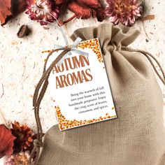 a brown bag filled with autumn flowers next to a tag that says autumn aromas