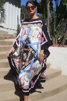 Designer print kaftan for dressy or casual wear.  Take on that cruise or just enjoy lounging elegantly or entertaining at home. One size.  Fits many sizes small to X-large.  The width is 52 inches, edge to edge, 104 around the body.  The side seams are 6 inches from the edge.  The length is 51 inches.  Machine wash on short, delicate cycle or hand wash. Chic Oversized Kaftan For Beach Cover-up, Chic Printed Beach Kaftan, Chic Long Silk Kaftan, Black Silk Maxi Dress For Vacation, Chic Printed Summer Kaftan, Elegant Printed Beach Kaftan, Chic Beach Season Kaftan For Vacation, Chic Printed Kaftan For Spring, Chic Long Kaftan For Beach