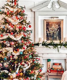 a decorated christmas tree in the corner of a living room with a fireplace and painting on the wall