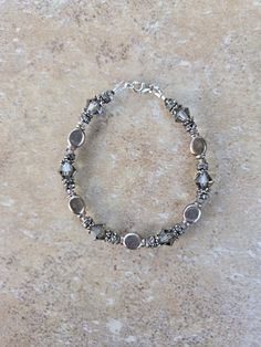 Sterling Silver and Swarovski Crystal Handmade Bracelet, 7.5". All beads are sterling including lobster clasp. Swarovski crystals are 2mm and 8mm bicone Black Diamond.  Check out my other jewelry at https://loveofjewelryshop.etsy.com Adjustable Faceted Sterling Silver Crystal Bracelet, Silver Crystal Bracelets With Faceted Detail, Adjustable Beaded Crystal Bracelet For Anniversary, Sterling Silver Beaded Crystal Bracelet Gift, Adjustable Sterling Silver Bracelet With Faceted Beads, Sterling Silver Crystal Bracelet With Round Beads, Silver Beaded Crystal Bracelet As Gift, Elegant Sterling Silver Crystal Bracelet With Faceted Beads, Elegant Silver Crystal Bracelet With Faceted Beads