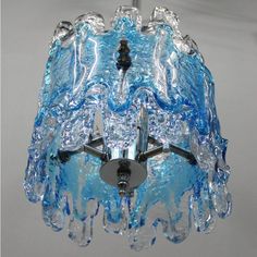 a blue glass chandelier hanging from a ceiling