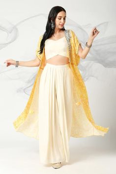 Canary yellow cape with floral print and mirror, sequin, resham embroidered placket. Paired with solid off-white bustier and pleated flared pant.
Components: 3
Pattern: Printed, Embroidery
Type Of Work: Floral, mirror, sequin, resham
Neckline: Cape: Open, Bustier: V neck
Sleeve Type: Cape: Half sleeves, Bustier: Sleeveless
Fabric: Muslin Silk
Color: Yellow
Other Details: 
Inverted V hem
Pleated pant
Front tassel tie-up
Approx. product weight: 1 kgs
Model height: 5ft 7inches, wearing size S
Occas Summer Festive Palazzo Set With Cape Sleeves, Cotton Dupatta For Party, Cape Sleeves Palazzo Set With Dupatta, Palazzo Set With Cape Sleeves And Dupatta, Party Sets With Back Tassel Tie-up, Yellow Festive Sets With Cape Sleeves, Festive Yellow Sets With Cape Sleeves, Festive Spring Cape Set, Silk Cape