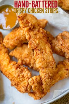 fried crispy chicken strips on a plate with dipping sauce