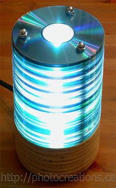 a light that is sitting on top of a wooden table next to a cd case