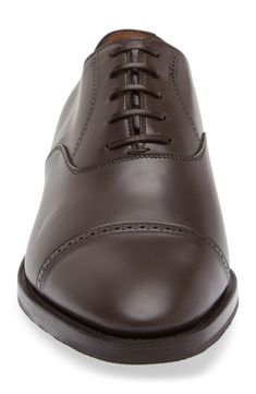 Epitomizing minimalist styling and expert craftsmanship, this sleek leather oxford crafted in Britain is cut with a softly tapered cap toe with brogued details. Lace-up style Leather upper and lining/synthetic sole Made in the UK Designer Shoes Timeless Fitted Goodyear Welted Oxfords, Goodyear Welted Cap Toe Oxford For Derby, Cap Toe Oxford Shoes With Goodyear Welted, Classic Leather Shoes For Derby, Classic Fitted Leather Shoes For Derby, Timeless Oxfords With Leather Lining, Fitted Calf Leather Oxfords For Derby, Fitted Goodyear Welted Cap Toe Derby, Leather Oxford Shoes With Goodyear Welt For Derby