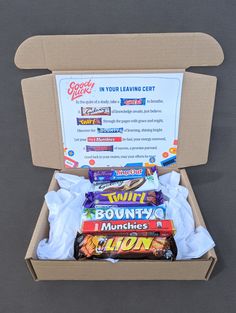 an open cardboard box containing several different types of snacks and candy bars, with information about their flavors