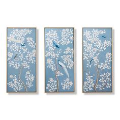 three paintings with birds on them in blue and white colors, hanging on the wall