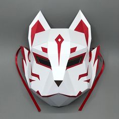 a paper mask made to look like an animal's head with red and white stripes