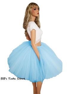 Experience the joy of twirling and feeling absolutely beautiful with our made-to-order Plus Size Mid Length Tutu. This enchanting skirt is lovingly crafted by tying strips of premium tulle to a comfortable elastic waistband, ensuring a perfect fit that accentuates your natural curves. Measuring 20 inches long, this tutu strikes the ideal balance between elegance and playfulness, allowing you to radiate confidence and grace with every step. Its versatile length ensures that it flatters a variety Adult Tulle Skirt, Long Tutu, Radiate Confidence, Natural Curves, Beautiful Skirts, Everyday Wardrobe, How To Feel Beautiful, You Choose, Mid Length