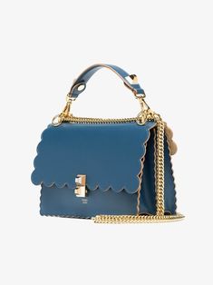 This blue calf leather Kan I scalloped handbag from Fendi features a foldover top with flip-lock closure, a top handle, a chain and leather strap, interior compartments divided by a partition and gold tone hardware. Bag with flap and two-tone plexiglass double stud fastening. The gusseted interior features a pocket and two compartments divided by a stiff partition. Can be worn cross-body or carried by hand thanks to the detachable shoulder strap. Made of deep blue leather with gold metal hardwar Fendi Kan I, Double Stud, Blue Leather Bag, Fendi Shoulder Bag, Louis Vuitton Fashion, Timeless Handbag, Leather Top, Dior Bag, Blue Leather