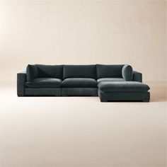 a large sectional couch sitting on top of a white floor