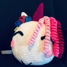 a crocheted stuffed animal that looks like a unicorn's head with horns