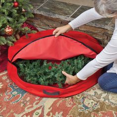 The holidays are over, now time to put your decorations away! This roomy wreath storage bag won’t compromise the shape or style of your wreath. This lightweight polyester bag will preserve your wreaths and comes with a sturdy handle for easy carrying. Features: Wreath storage bag Holds up to 36” a diameter wreath Features a dual sided zipper closure Features a handle for easy transport Durable lightweight fabric that resists tearing Recommended for indoor use - if using outdoors place under a covered area Dimensions: 6” high x 36” diameter Material(s): polyester/metal Wreath Storage Containers, Christmas Wreath Storage, Red Christmas Wreath, Wreath Storage, Artificial Wreath, Christmas Room, Christmas Accessories, Christmas Store, Simple Living