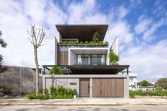 an apartment building with plants growing on the roof