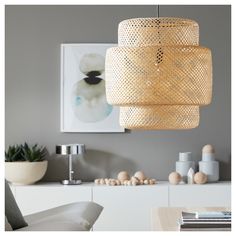 a living room filled with furniture and a large light fixture hanging over it's head