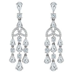 Sweet and sultry, the Eterna Diamond Earrings are a delicate yet impactful pair. They are a classic that can be worn to impress on a casual evening out or for a more stated look. Diamonds Shape: Pear Shape & Round Side Diamonds Weight: 4.21 ct Side Diamond Color: H - I Side Diamond Clarity: VS (Very Slightly Included) Metal: 14K White Gold Metal Wt: 9.13 gms Setting: Prong Set Length: 1.73 Inches (4.4 cm) Non Threaded Post & Push Back Closure Vintage Drop Earrings, Casual Evening, Diamond Color, Diamond Clarity, Pear Shape, Diamond White, Diamond Shapes, Prong Setting, Colored Diamonds