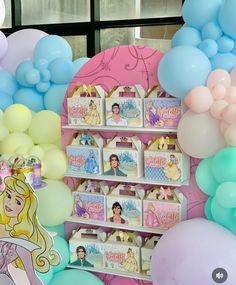 there is a display with balloons and princesses on it