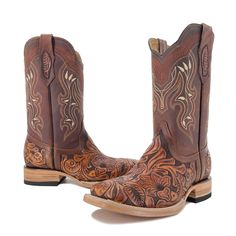 These handmade men's boots featuring handtooled leather and a square toe offer a classic western style. The Bulldog Hand Tooled Boots- Brown Bitone are a stylish and durable addition to any wardrobe. The vamp, heel and pull straps are hand tooled. Authentic Cowhide Leather Cow Leather Shaft Stitched sole Western Leather Boots With Concho, Western Style Moto Boots For Western-themed Events, Western Moto Boots With Square Toe And Leather Sole, Western Style Moto Boots With Square Toe, Brown Moc Toe Western Moto Boots, Brown Concho Boots For Western-themed Events, Western Moto Boots With Goodyear Welt For Rodeo, Hand Tooled Brown Boots For Western-themed Events, Brown Hand Tooled Boots For Western-themed Events