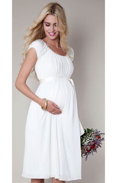 Adored for its stunning simplicity, our popular Claudia maternity wedding dress now comes in a demure knee-length version that's perfect for an intimate country house wedding. Flowy Empire Waist Maternity Dress For Wedding, Elegant Flowy Maternity Dress With Empire Waist, Flowy White Maternity Dress For Wedding, Elegant White Maternity Wedding Dress, Elegant Cream Maternity Dress, Elegant White Maternity Dress For Bridal Shower, Elegant White Maternity Bridesmaid Dress, Tiffany Rose, Dresses For Pregnant Women