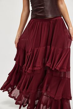 Timeless and tiered, this essential maxi skirt is the perfect transeasonal staple. **Fit:** Mid-rise, billowy tiered silhouette **Features:** Pull-on design, semi-sheer paneling, ruffle detailing, partially lined **Why We ❤ It:** Sleek with strappy heels or unexpected with sneakers, this style has endless ways to wear. | Clementine Maxi Skirt by Free People in Red, Size: XS Flowy Maxi Skirt With Layered Hem, Tiered Maxi Skirt With Layered Hem, Layered Tiered Skirt Maxi Dress, Elegant Tiered Voluminous Maxi Skirt, Layered Voluminous Tiered Skirt, Red Tiered Maxi Dress With Ruffles, Flowy Tiered Layered Skirt, Red Tiered Ruffle Maxi Skirt, Tiered Ruffled Maxi Skirt