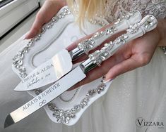 a woman holding two knives in front of her wedding cake knife holder with the name always & forever on it