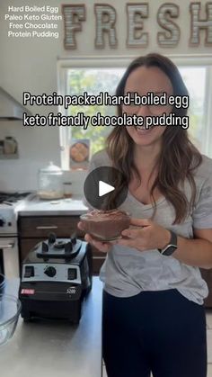 a woman standing in a kitchen holding a chocolate doughnut with the words protein packed hard boiled egg keto friendly chocolate pudding