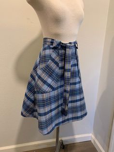 1970's Vintage Wrap Around Skirt ~ Navy Blue Vintage Plaid Print Skirt, Very Good Condition The two last photo shows its small issues. I will be mailing it Priority Mail and First Class International. Measurements Adjustable Waist ~ 26 Inch Length ~ 22 Inch Retro High Waist Skirt For School, Retro School Mini Skirt, Retro Cotton Pleated Skort, Retro Pleated Cotton Skort, Retro Cotton Bottoms For School, Retro Pleated Skort For School, Retro Cotton School Bottoms, Retro Blue Fitted Skort, Blue Retro Cotton Skort