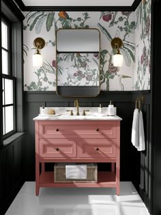 a bathroom with pink vanity and blue walls