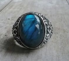 solid large labradorite ring mans wedding or dress ring beautiful scroll antique effect. solid sterling silver (925) Solid not hollowed out in the back stone flashes blues and grey with black flecks..few inclusions. Avaliable in many stones Stone measures 17 mm x13mm (6/8 ''x 4/8'' approx.) The stone will be set once sold.1 This ring I can make any size. It weights 12.2 gms approx It is 21mm (7/8 '' wide) It tapers to 3.5mmat the back If a different size is required pls convo me Spiritual Style Open Promise Ring, Spiritual Open Promise Ring, Elegant Formal Jewelry With Large Stone, Spiritual Metal Open Ring Jewelry, Spiritual Gemstone Ring, Unique Adjustable Ring With Round Stone, Unique Adjustable Rings With Round Stone, Adjustable Moonstone Ring In Fine Jewelry Style, Adjustable Fine Jewelry Moonstone Ring