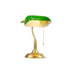 a green and gold desk lamp on a white background