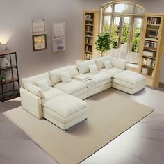 a large white sectional couch sitting on top of a rug in front of a window