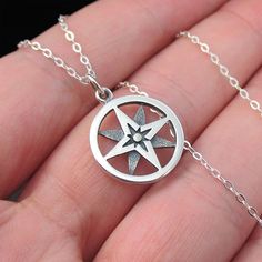 This necklace features a round openwork sterling silver north star compass charm on a delicate sterling silver chain. The compass has long been considered a good luck charm and a symbol of protection and guidance while the North Star represents inspiration, hope, and limitless possibilities. Pendant Diameter 15 mm Chain Type Cable Chain Width 1.3mm Clasp Type Spring Ring Chain Length 16,18,20" Metal Sterling Silver Color Sterling Silver Metal Purity 925 Production Time 2-3 Business Days Sterling Silver Medallion Jewelry With Star Charm, Sterling Silver Star Charm Necklace, Sterling Silver Star-shaped Jewelry With Compass Design, Symbolic Sterling Silver Necklace With Compass Design, Symbolic Sterling Silver Jewelry With Compass Design, Silver Medallion Charm Necklace With Compass Design, Silver Star-shaped Necklace With Compass Design, Symbol Of Protection, The North Star