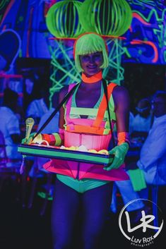 a woman with neon green hair holding a tray