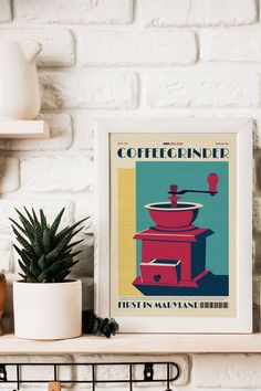 a coffee grinder poster sitting on top of a shelf next to a potted plant