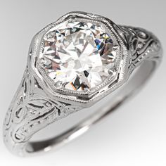 an antique style diamond engagement ring with filigrees