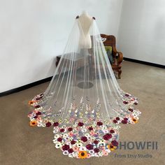 a wedding veil with flowers on the bottom