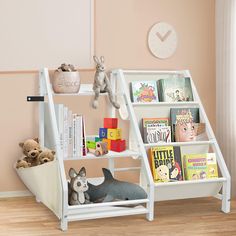 a white book shelf with books and stuffed animals